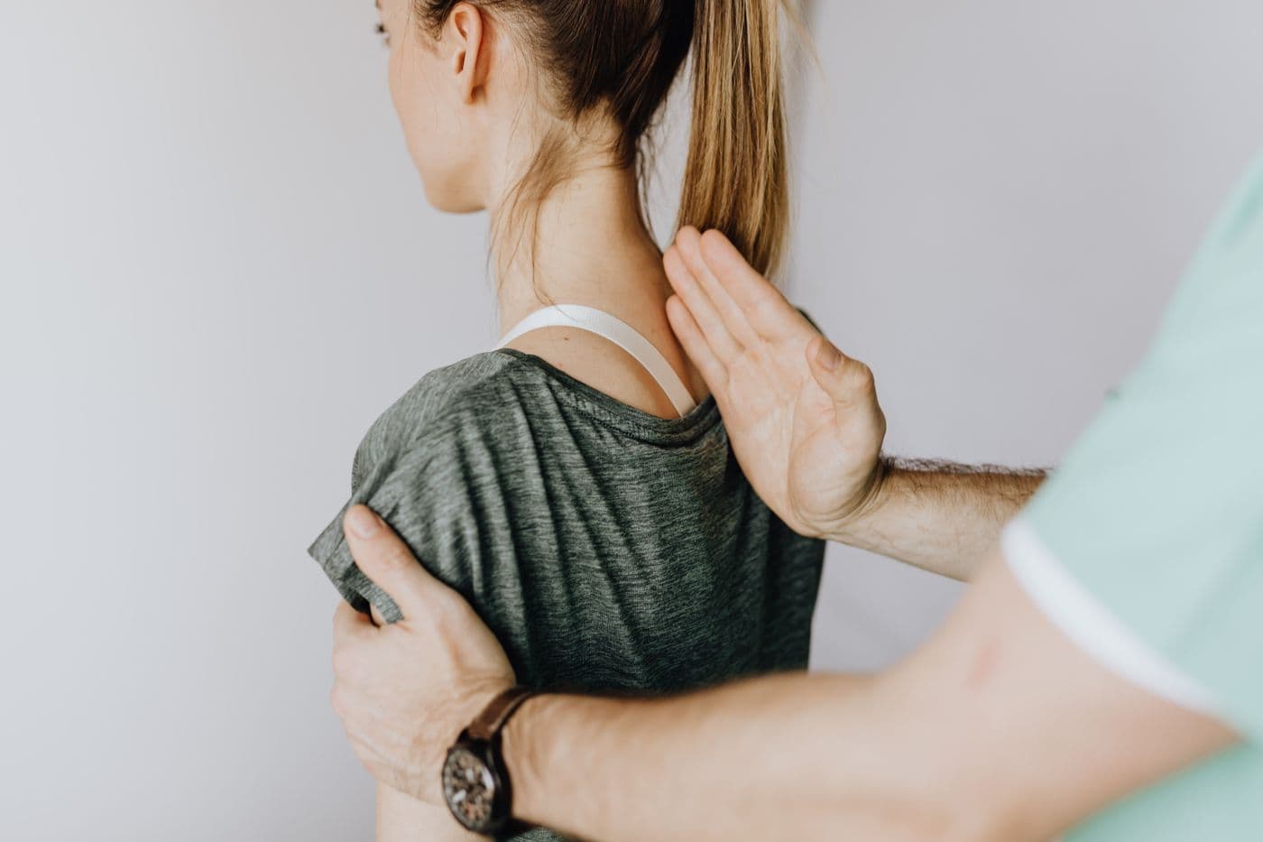 Clinician assessing posture and spinal alignment